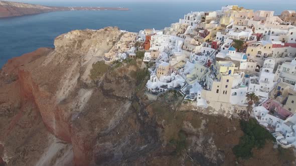 Flying over beautiful and famous Oia on Santorini Island in Greece during sunrise alt