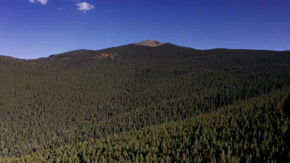 Aerial 4k wide shot. Drone flying over scenic fall colors in the Colorado Rocky Mountains.