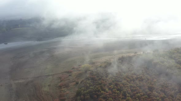 Flight Over A Dry Dam In The Autumn Foggy Day In The Morning