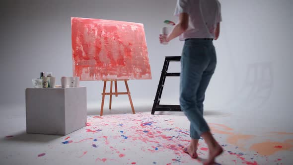 Slow Motion Female Artist Draws with a Brush on a Large Canvas in a White Room a Talented Artist alt