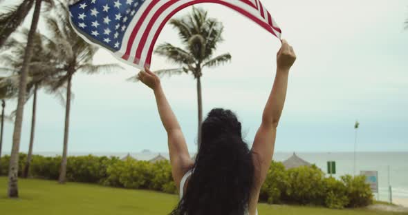 Patriotism Independence Day and Holidays Concept Happy Smiling Young Woman in Swimsuit with National alt