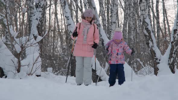 Girl with Mother Cross Country Skiing in Siberia alt