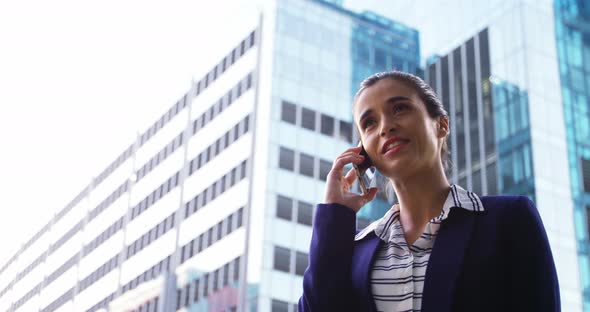 Businesswoman talking on mobile phone alt