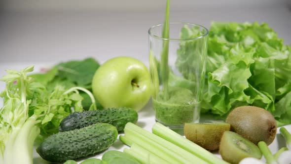 Healthy Concept with Green Antioxidant Organic Vegetables Fruits and Herbs and Fresh Smoothie