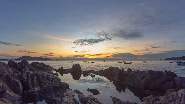 Time Lapse Scenery Sunset Above The Rock Beside The Beach. alt