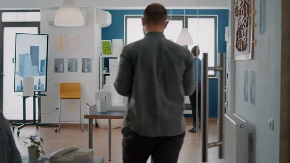 Man Architect Placing Blueprints Plan on Table to Design Building Model and Layout alt