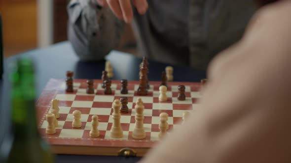 People Playing Chess Board Games on Wooden Table at Home alt