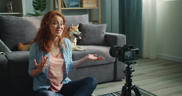 Beautiful Blogger and Cute Dog Recording Video Using Camera at Home Talking alt