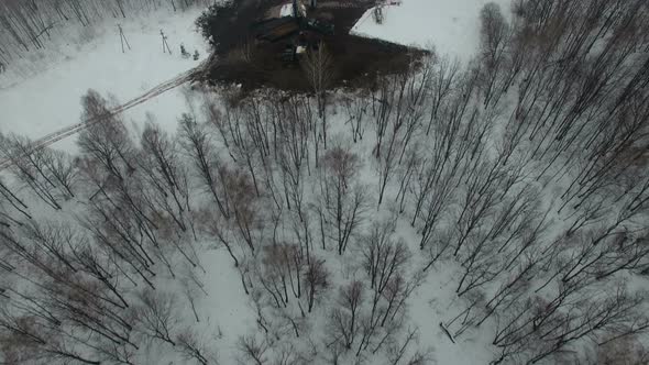Drilling a Deep Well with a Drilling Rig in an Oil and Gas Field in Winter Forest. The Field Is