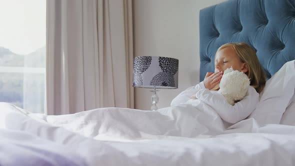 Girl stretching her arms while waking up in bedroom 4k alt