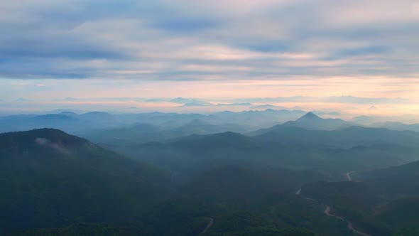 4K aerial view from a drone flying over the valley, fog in the morning. alt