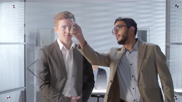 Diverse Businessmen Using Invisible Touch Screen and Talking in Office alt