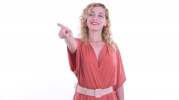 Happy Beautiful Blonde Businesswoman Pointing Finger and Directing alt