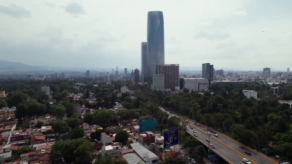 Aerial View Of Centro Comercial Mítikah Beside Rio Churubusco Avenue. Dolly Forward alt