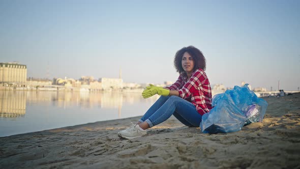 Lady Looks at Bank with Satisfied Expression After Cleaning alt