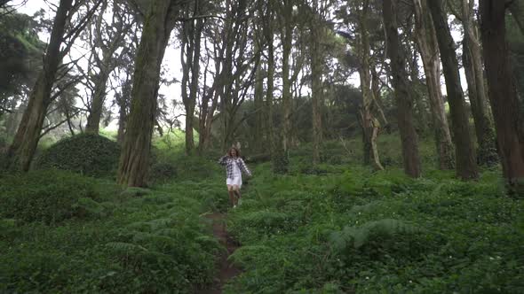 Beautiful young woman running in wonderland magic forest, Exploring fairytale nature, trees, stones