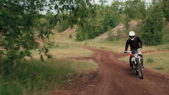 Motorcyclists Riding Off-Road in Forest alt