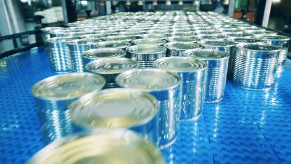 Factory Conveyor is Transporting Newlysealed Tin Cans alt