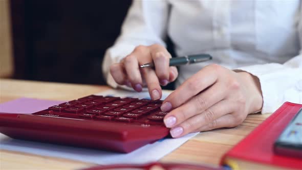 Businesswoman Is Monitoring Statistics On Calculator