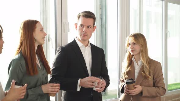 American Businessman Communicates with Colleagues During Coffee Break