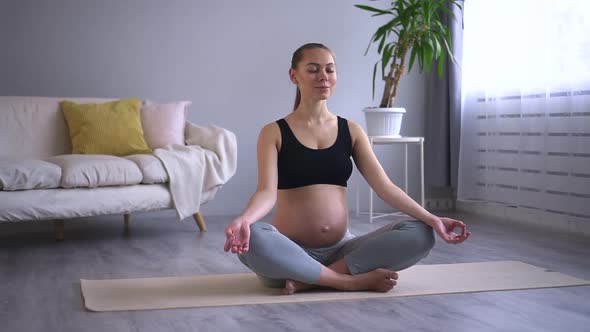 Healthcare and Prenatal Yoga Woman Meditates in Living Room Spbd alt