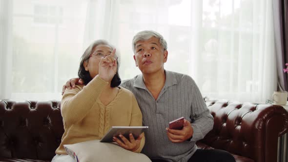 Senior couple use transparent AR screen at home