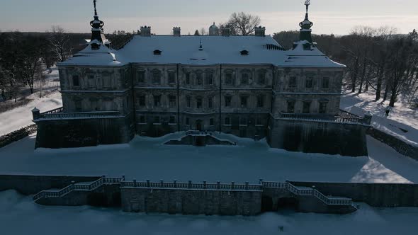 Aerial View Drone Flight Backward Over the Historic Old Castle at Sunny Winter Day Pidhirtsi Palace