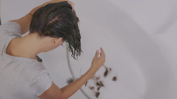 Hair Problems. The Girl's Hair Falls Out Into the Sink While Washing alt