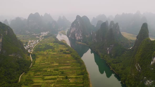Aerial shot of the amazing rock formations along the Li River in China alt