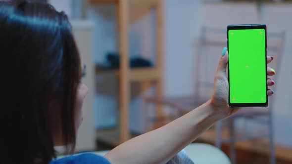 Housewife Holding Smartphone with Green Screen alt