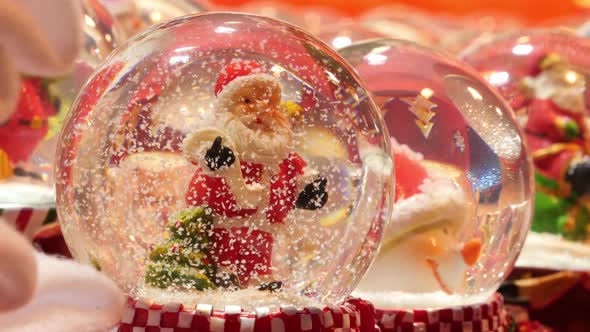 Christmas snow globes on display in a store