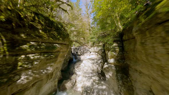 FPV Drone Extreme Shot Flying Over Natural Canyon Cliff Formation with Tropical Plant Greenery alt