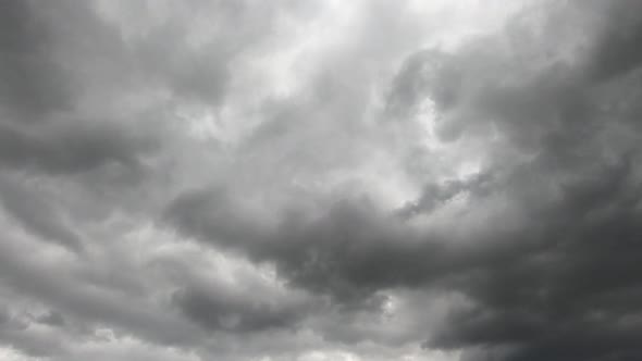 Time lapse of storm clouds moving fast in sky. Static, low angle alt