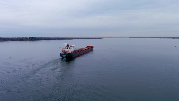 4K aerial footage of a self discharging bulk carrier ship sailing the St Lawrence River.