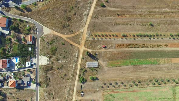 Aerial view of paved road intersecting with dirt road, Stock Footage