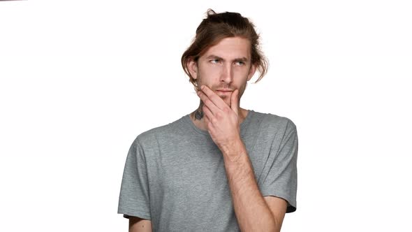 Portrait of Unshaved Guy Posing with Concentrated Look and Hesitating or Trying to Remember Isolated alt
