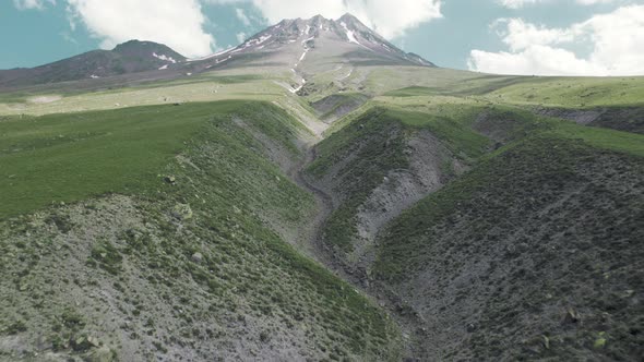 Drone Flies to Mountain Over the Surface