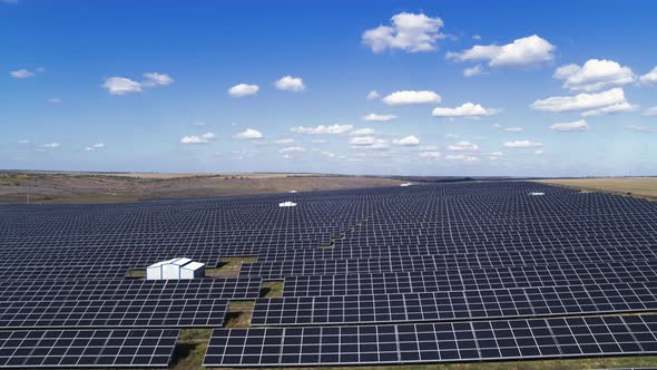 Aerial View of Solar Farm on the Green Field at Sunset Time Solar Panels in Row