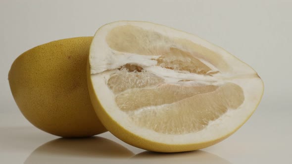 Close-up of Citrus maxima grandis halves 4K 2160p 30fps UltraHD  tilting footage - Pomello fruit  pi alt