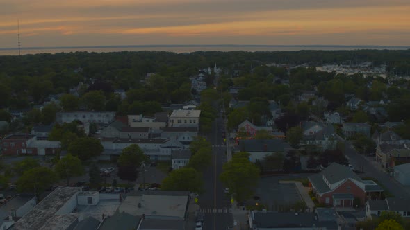Lowering Aerial View of Suburban Houses in Greenport Long Island at Sunset alt