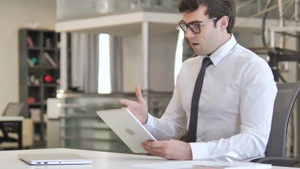 Businessman Reacting to Online Loss on Tablet alt