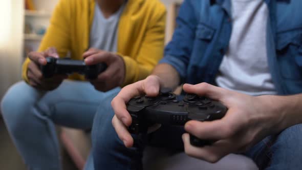 Overemotional Multiethnic Teenage Boys Winning Computer Game, Hands Close-Up alt