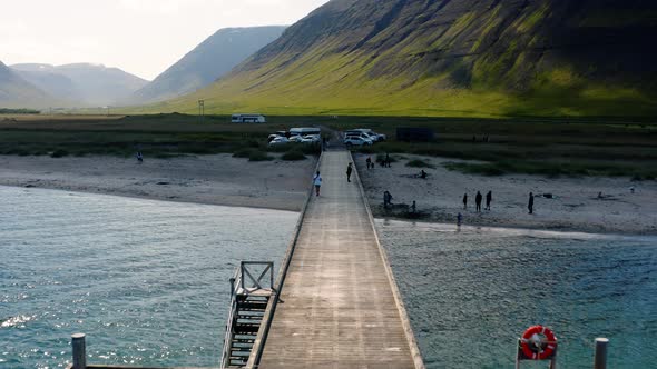 People At Holtsbryggja Pier With Campground In Onundarfirdi Near The Village Of Flateyri