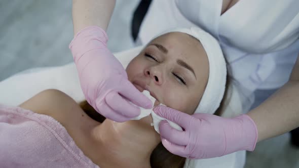 Young Woman Having Cleansing the Skin with Cotton Swabs During Beauty Procedure alt