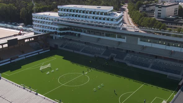 Training football team at Studentarnas Uppsala stadium, Sweden. Aerial sideways alt
