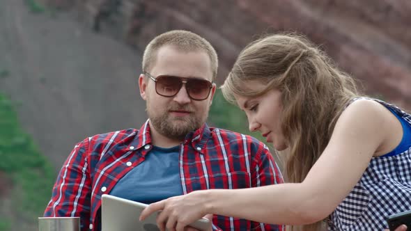 Young Couple Camping with Tablet alt