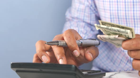 Close Up of Man Hand Using Calculator  alt