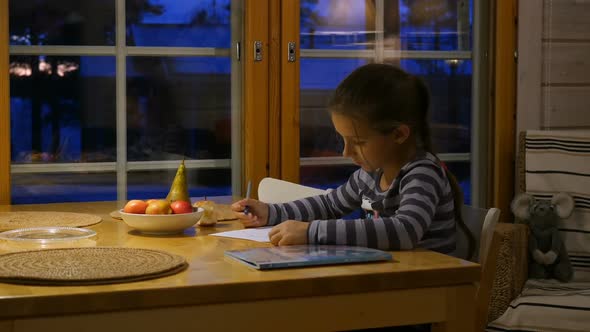 Pretty School Girl at Home, Writing a Homework. Child Sitting at Table and Write