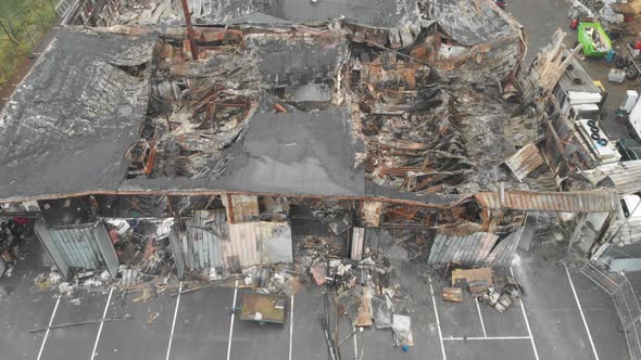 Flying Over Burnt Down Industrial Warehouse Collapsed Roof Aerial