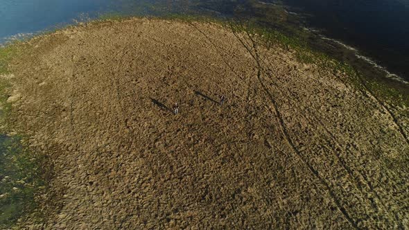 Two Men Stand in the Middle of a Spilled River in the Spring Floods